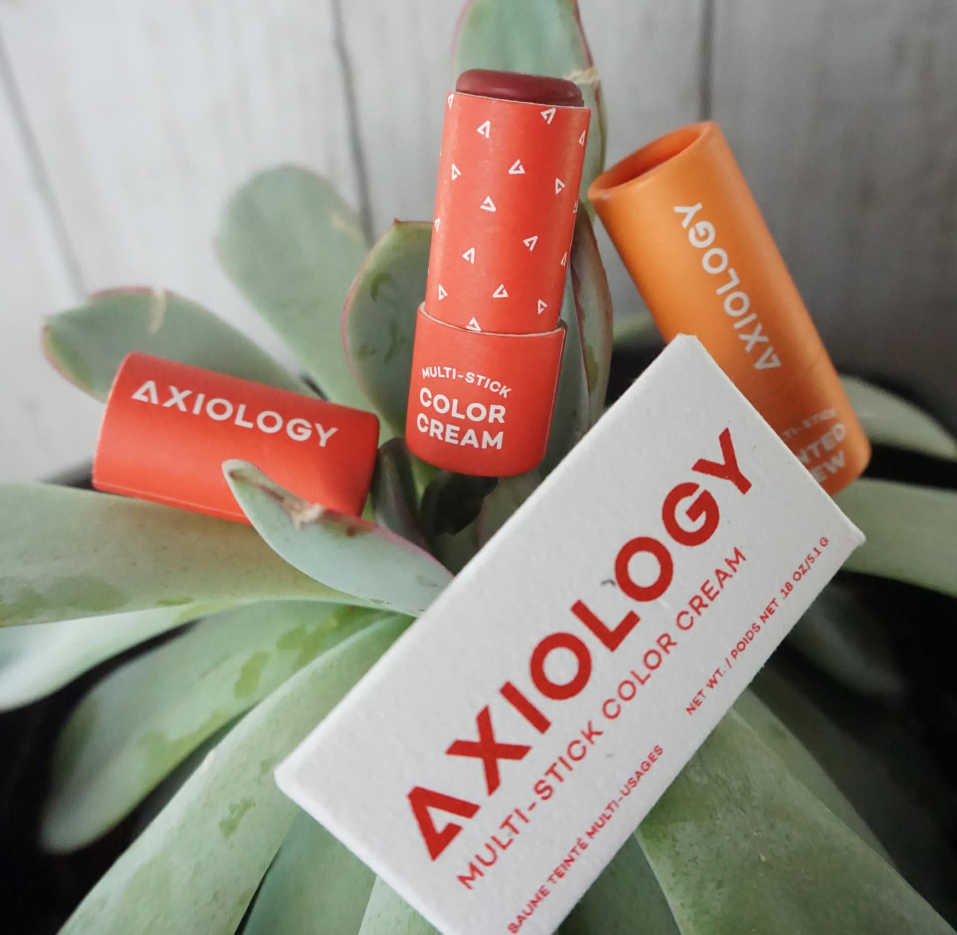Axiology Multi-Stick Color Cream tubes photographed by Sustainable Jungle, showcasing sustainable beauty products made with plastic-free, eco friendly packaging.